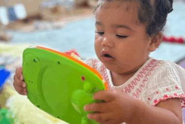 Toddler looking intently at a toy